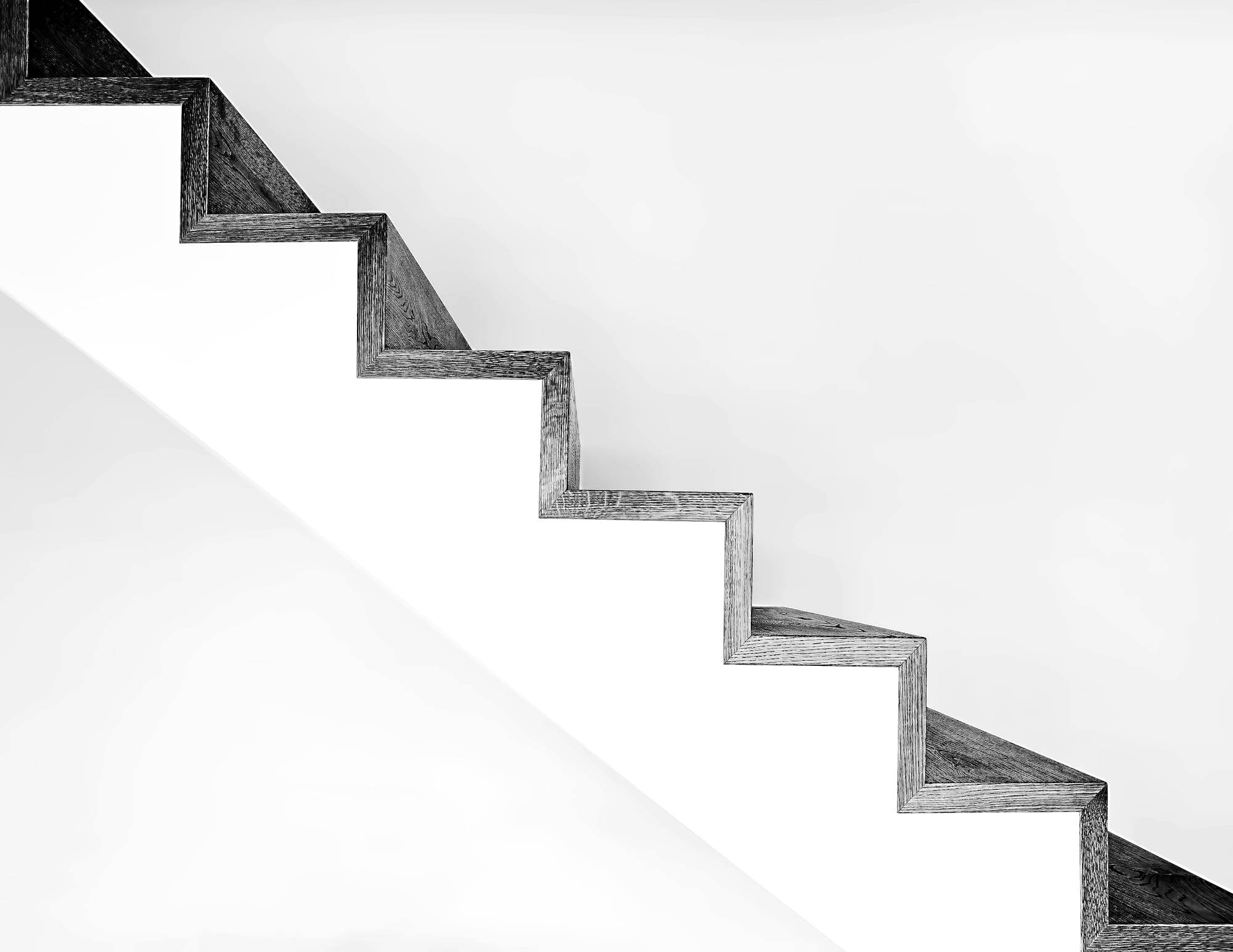 White concrete staircase with black metal railings