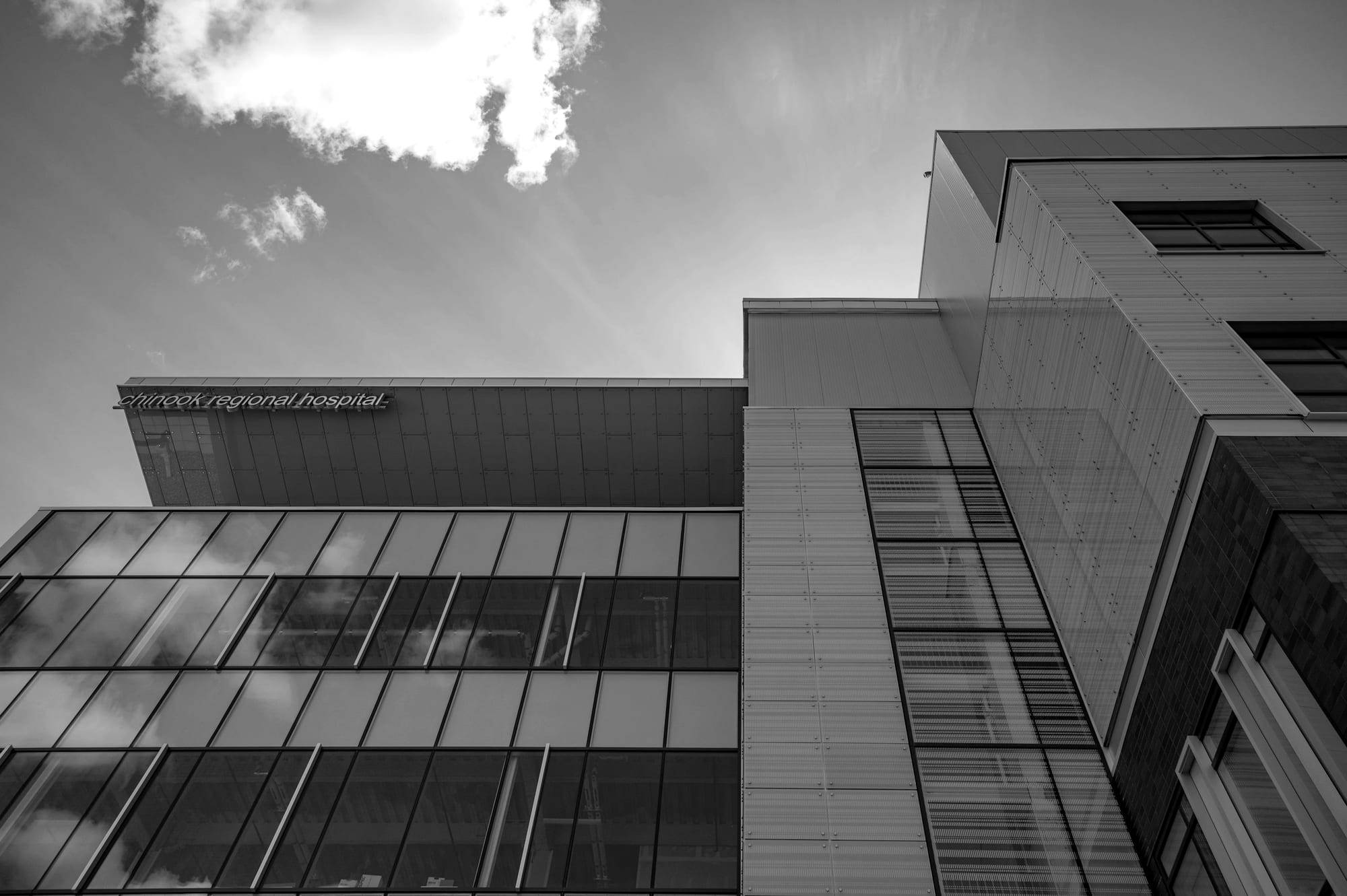 Exterior of a modern hospital building with a glass and steel facade