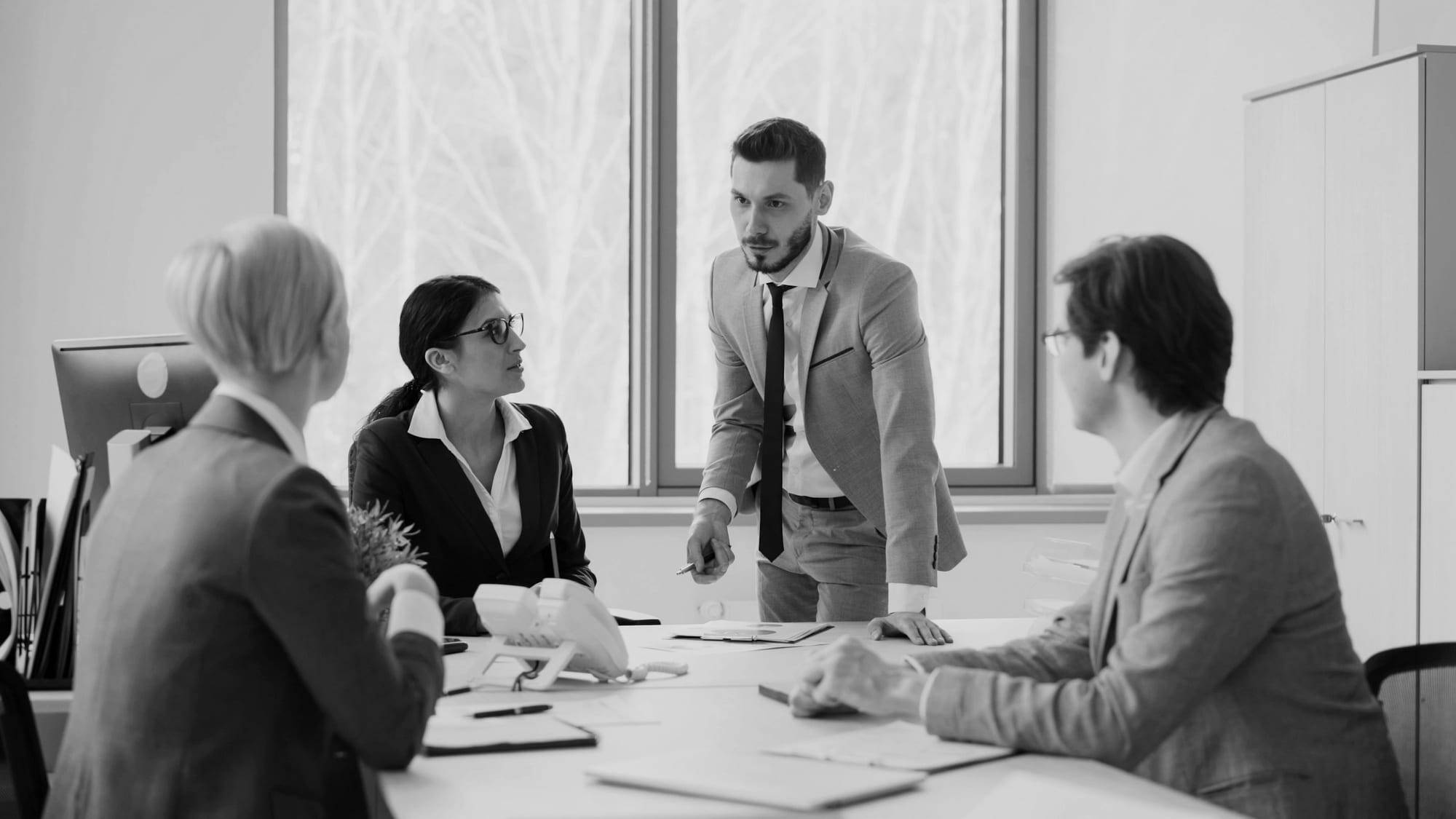 Business leaders in discussion around a meeting table