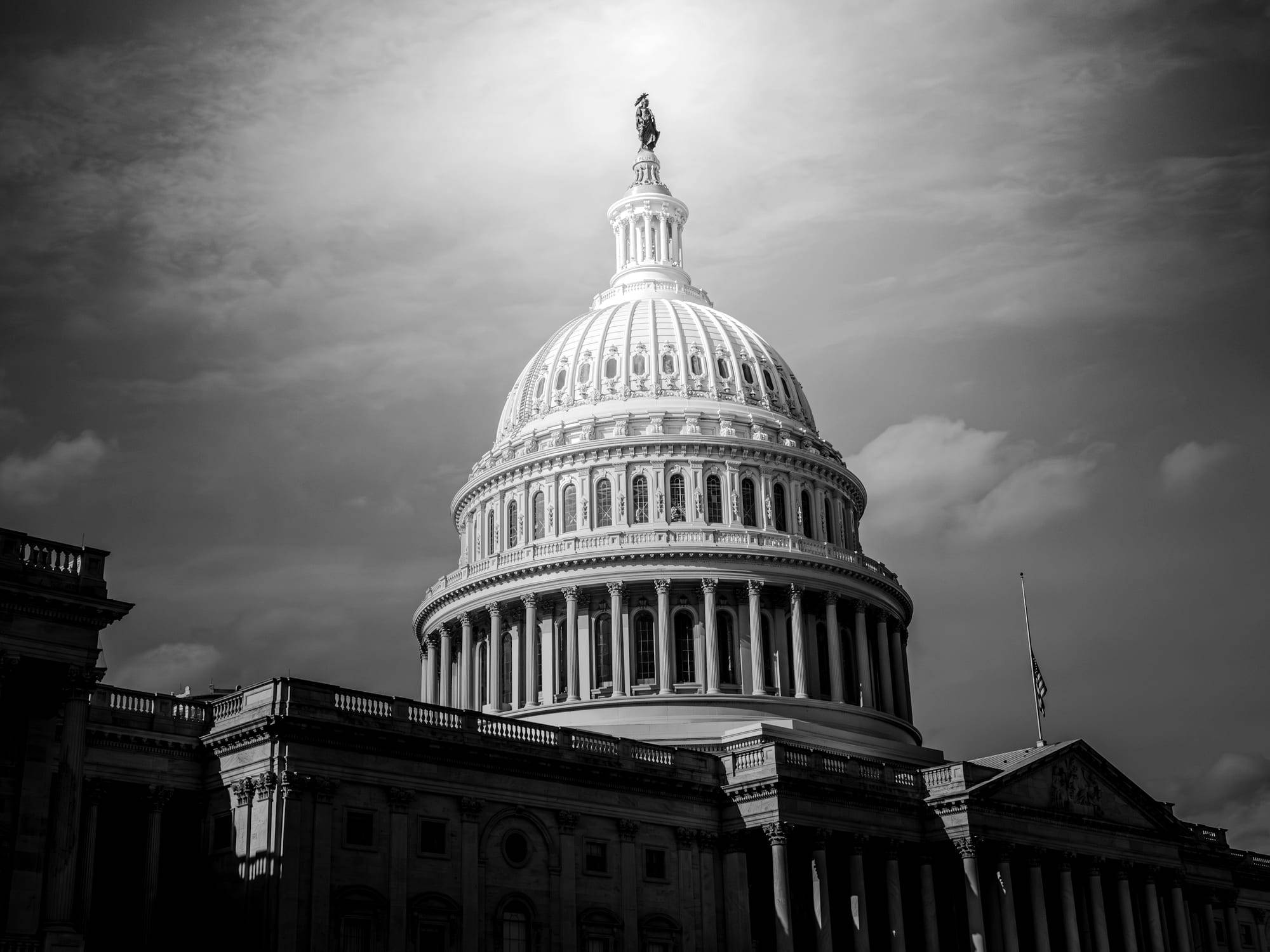The United States Capitol dome in Washington, DC against a clear sky