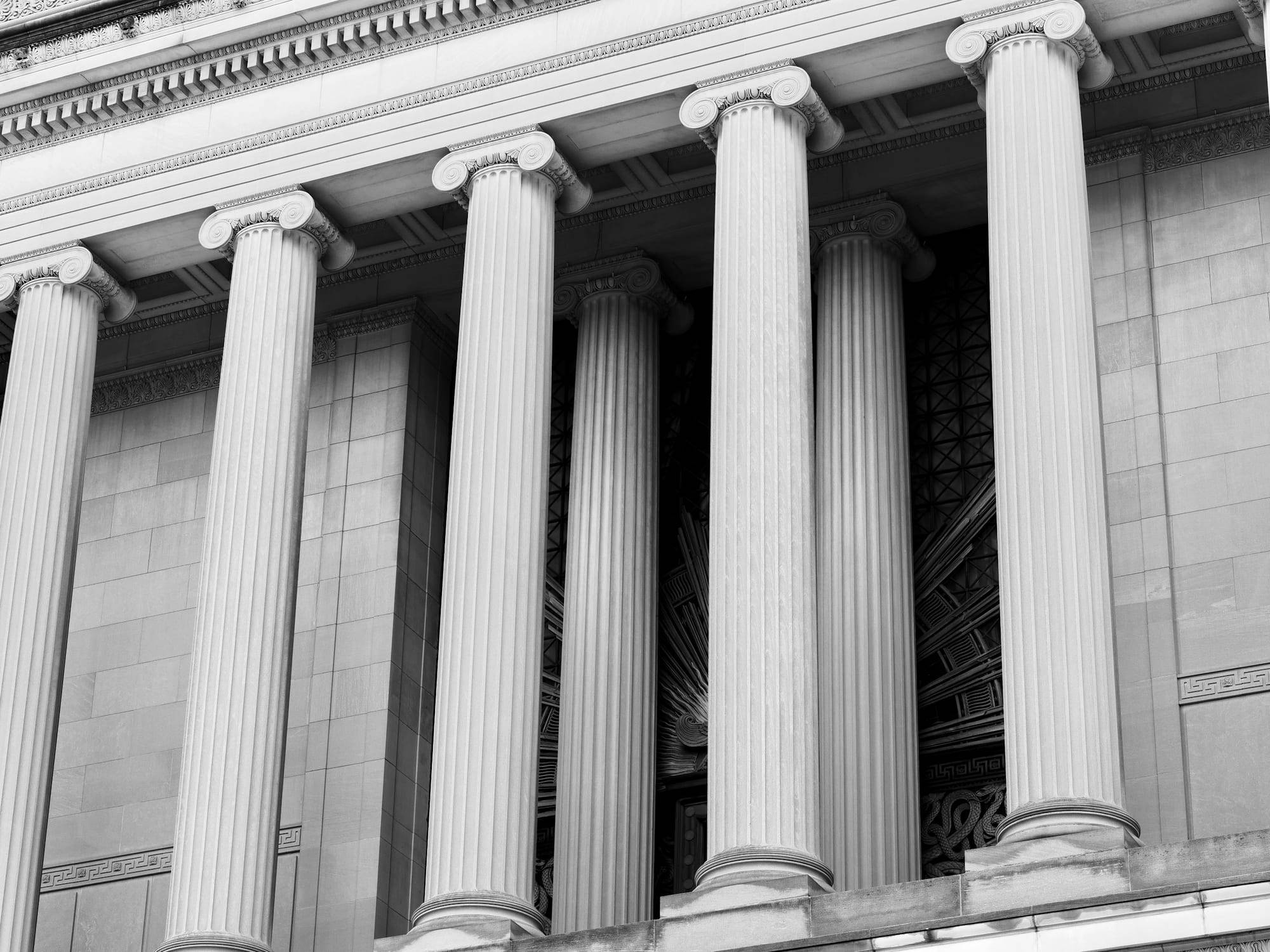 Row of classical stone columns on the facade of a financial institution
